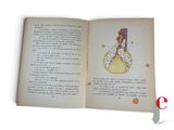 an open book with a picture of a woman sitting on a moon