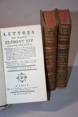 three old books sitting on a table next to each other