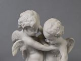 a statue of two little angels hugging each other