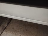 a white car that is parked on the side of the street