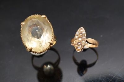 deux bagues en or et une bague en diamant posées sur un fond noir
