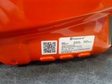 a close up of an orange motorcycle with a qr code on it