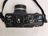 a black camera with a black strap attached to it