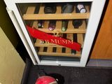 a microwave that has a wine rack in front of it