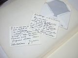 two old letters and a piece of paper on top of a book