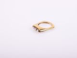 a gold ring on a white background