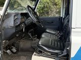 an image of a van that has been vandalized and is sitting in the grass