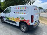 a close up of a van parked on the side of a road