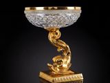 a gold and crystal bowl with a dragon on top