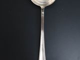 a close up of a spoon on a table with a black background