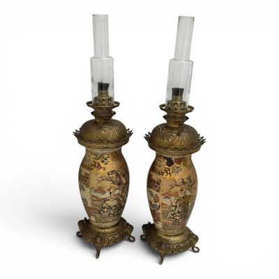 pair of antique brass candlesticks with asian scenes