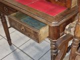 a wooden desk with a drawer on top of it