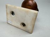 a small piece of marble with holes in it