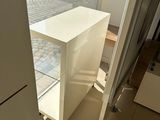 a small white table in the corner of a room