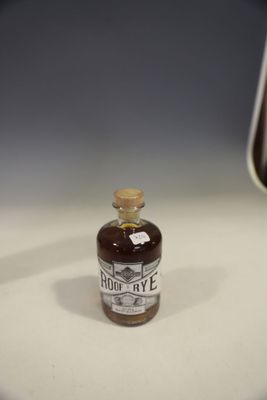 a bottle of liquor sitting on a table next to a bottle of liquor