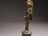 an image of a bronze statue of a woman holding a tennis racquet
