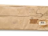 an old envelope with a stamp on it sitting on top of a white surface