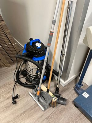 un aspirateur et un balai dans un coin de la pièce