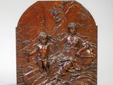 une image représentant une plaque en bronze sur laquelle figurent un homme et une femme à cheval