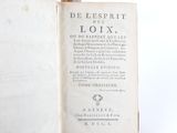 an old book with writing on it sitting on a table
