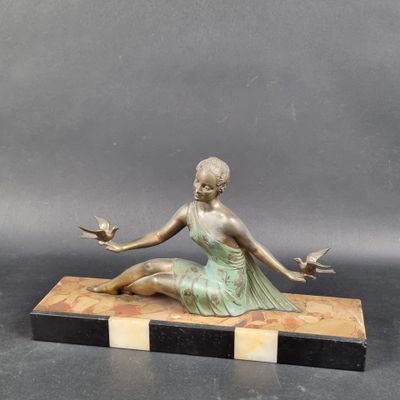 bronze statue of a woman sitting on a marble base