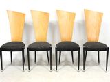four chairs with black upholstered seats and a wooden back