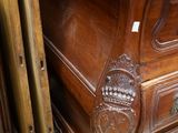 a wooden chest of drawers with a mirror on top of it