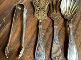 four spoons and a spoon rest on a wooden table