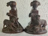 two figurines of a woman and a dog on a table