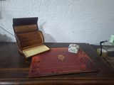a wooden table with a book and a dice on it