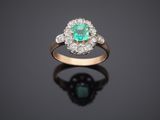 an emerald and diamond cluster ring
