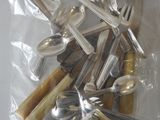 a lot of silverware in a bag on the table