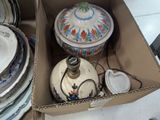 a box full of plates and bowls and a lamp