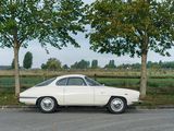 a white car that is parked on the side of the road