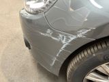 a close up of a car ' s headlight with graffiti on it