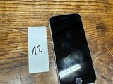a cell phone sitting next to a note on a wooden table