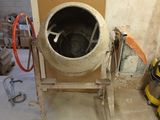 a cement mixer sitting in the corner of a room