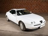 a picture of a white car parked in a parking lot