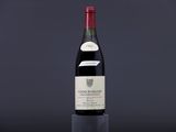 the bottle of wine is sitting on top of a glass
