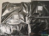 four bags of clothing sitting on top of a table