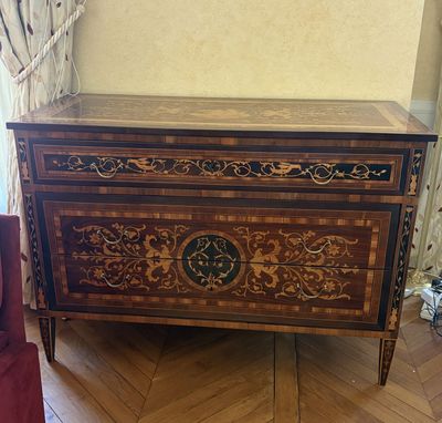 a chest of drawers in the corner of a room
