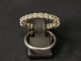 a close up of a diamond ring on a black surface