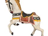 a white horse with a saddle on it ' s back
