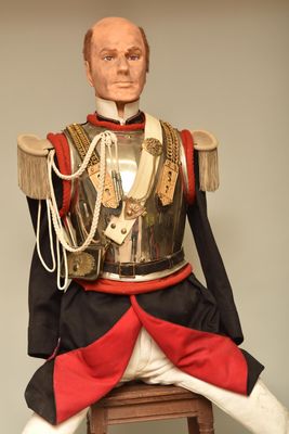 a statue of a man sitting on top of a stool