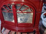 a red cabinet that has a glass door on it
