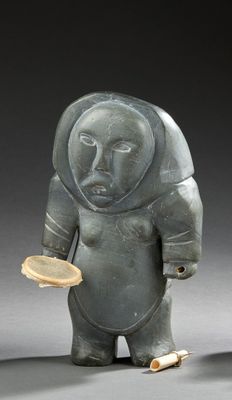 a statue of a man holding a brush and a bowl