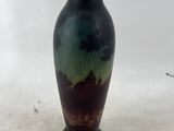 a vase that is sitting on a white surface