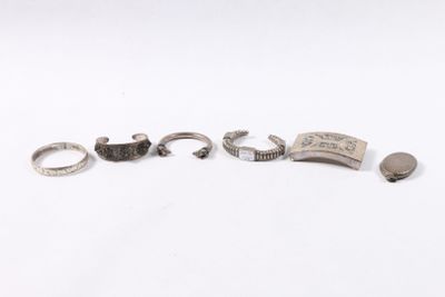 a group of five silver rings and a silver ring on a white surface