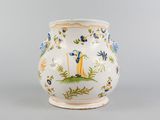 a white vase with a blue and yellow design on it