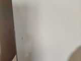 a shadow of a person standing in front of a refrigerator